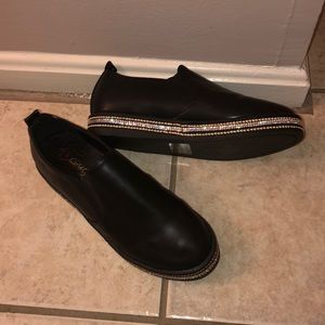 Black studded slip ons